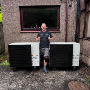 Cascade Air Source Heat Pump, staff member of eco partners in the middle.