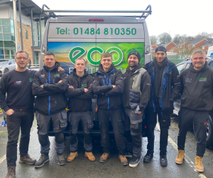 A team picture of 7 members of staff all stood side by side behind the eco partners signed van.