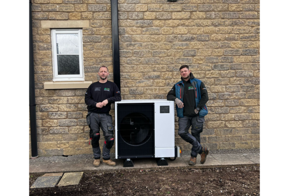 2 Men stood either side of an Air Source Heat Pump