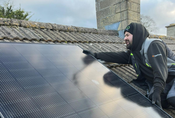 Eco Partners workman fitting renewable energy solar panel on roof