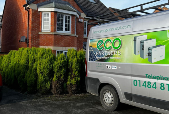 Eco Partners Van with a house in the background