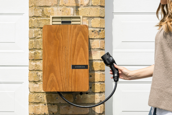 Image of a person holding an Andersen EV Charger.