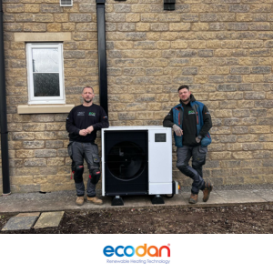 Eco Partners engineers beside a newly installed Mitsubishi Ecodan heat pump